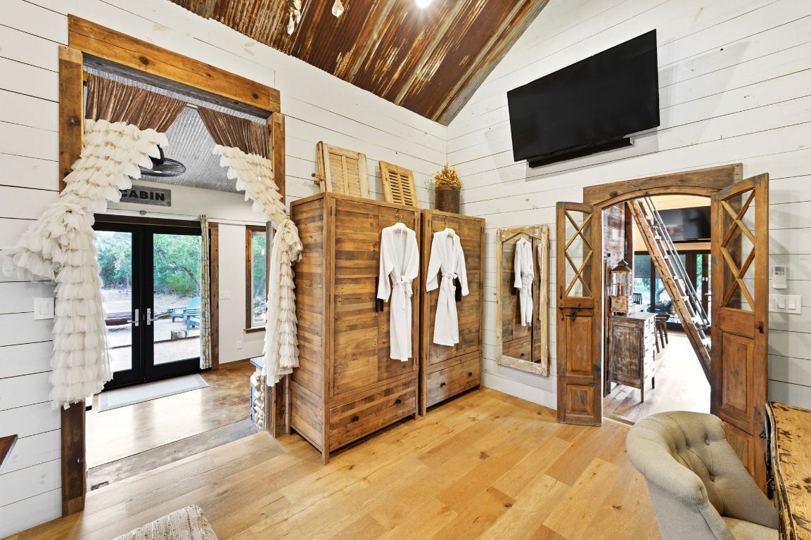 1910 Sandy Point Road Wimberley, TX 78676 - Photo 24 of 40 a view of a house with a flat screen tv on the wall