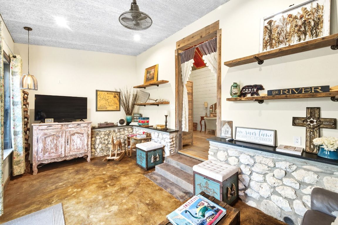 1910 Sandy Point Road Wimberley, TX 78676 - Photo 26 of 40 a living room with furniture and a flat screen tv