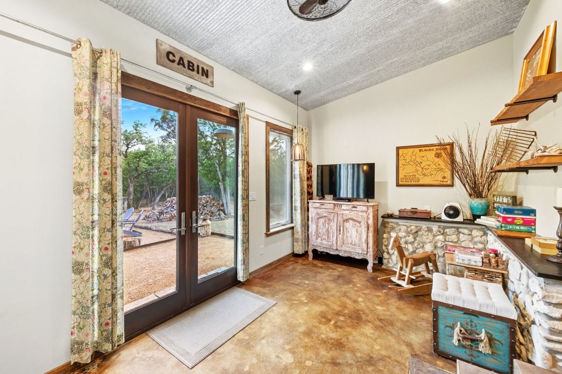 1910 Sandy Point Road Wimberley, TX 78676 - Photo 27 of 40 a living room with furniture and a flat screen tv