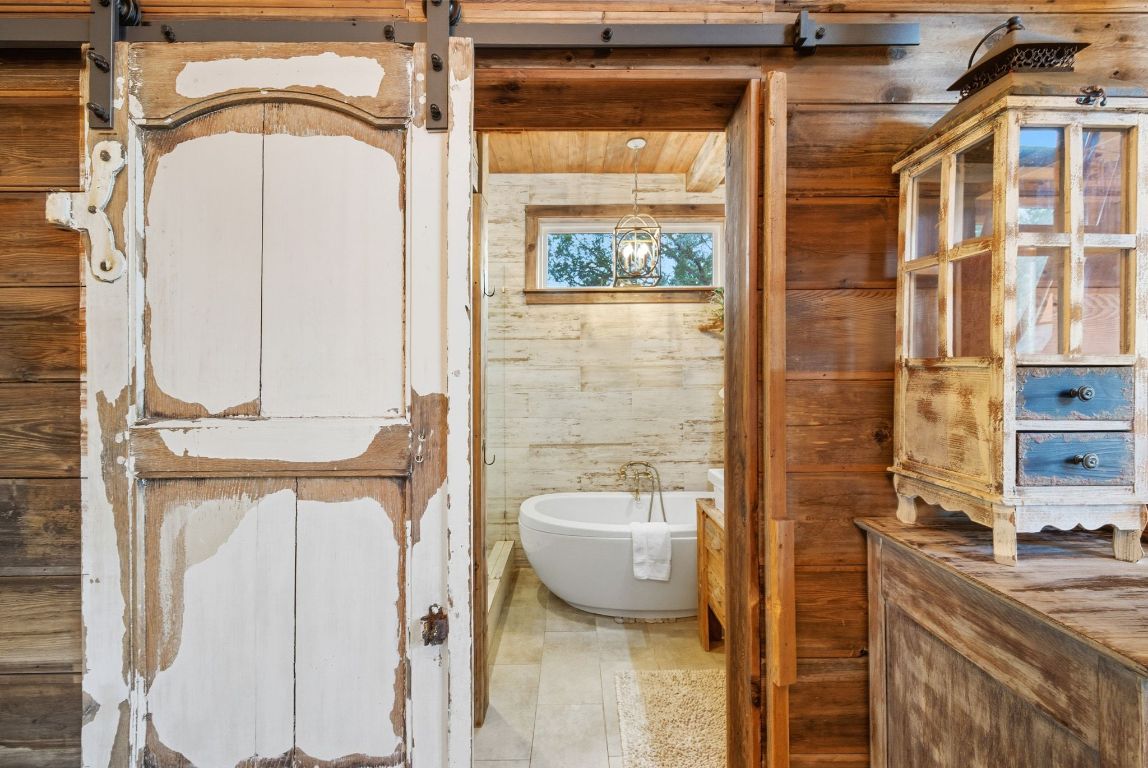 1910 Sandy Point Road Wimberley, TX 78676 - Photo 28 of 40 a bathroom with a granite countertop window and a shower