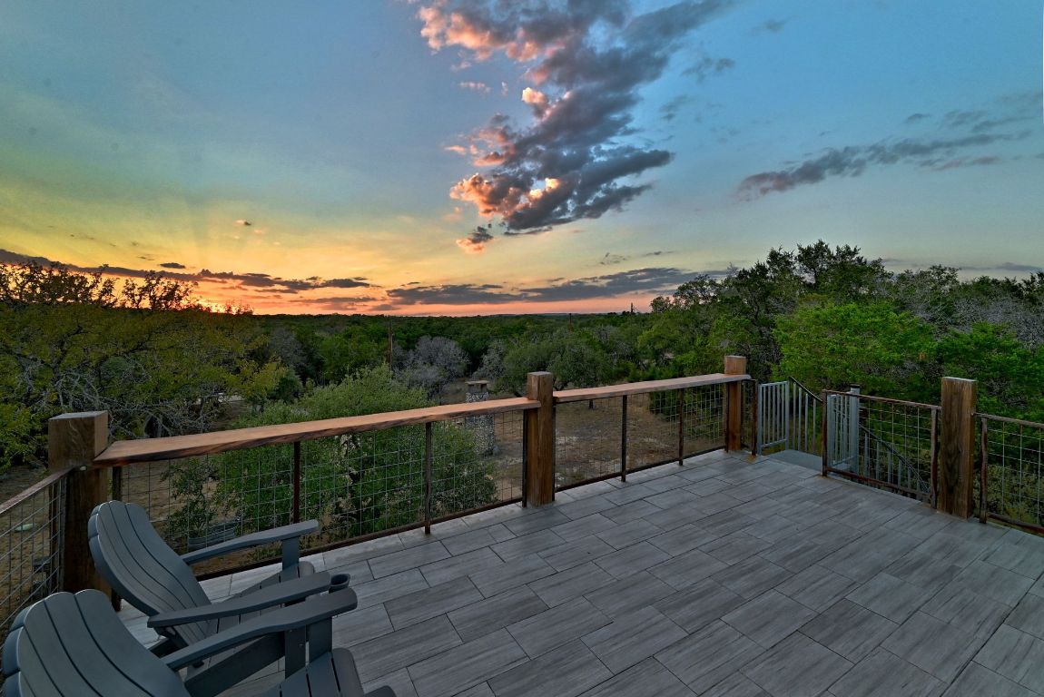 1910 Sandy Point Road Wimberley, TX 78676 - Photo 33 of 40 a view of a balcony with wooden floor and outdoor space