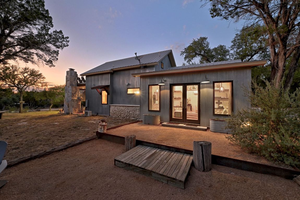 1910 Sandy Point Road Wimberley, TX 78676 - Photo 36 of 40 a view of a house with backyard and sitting area