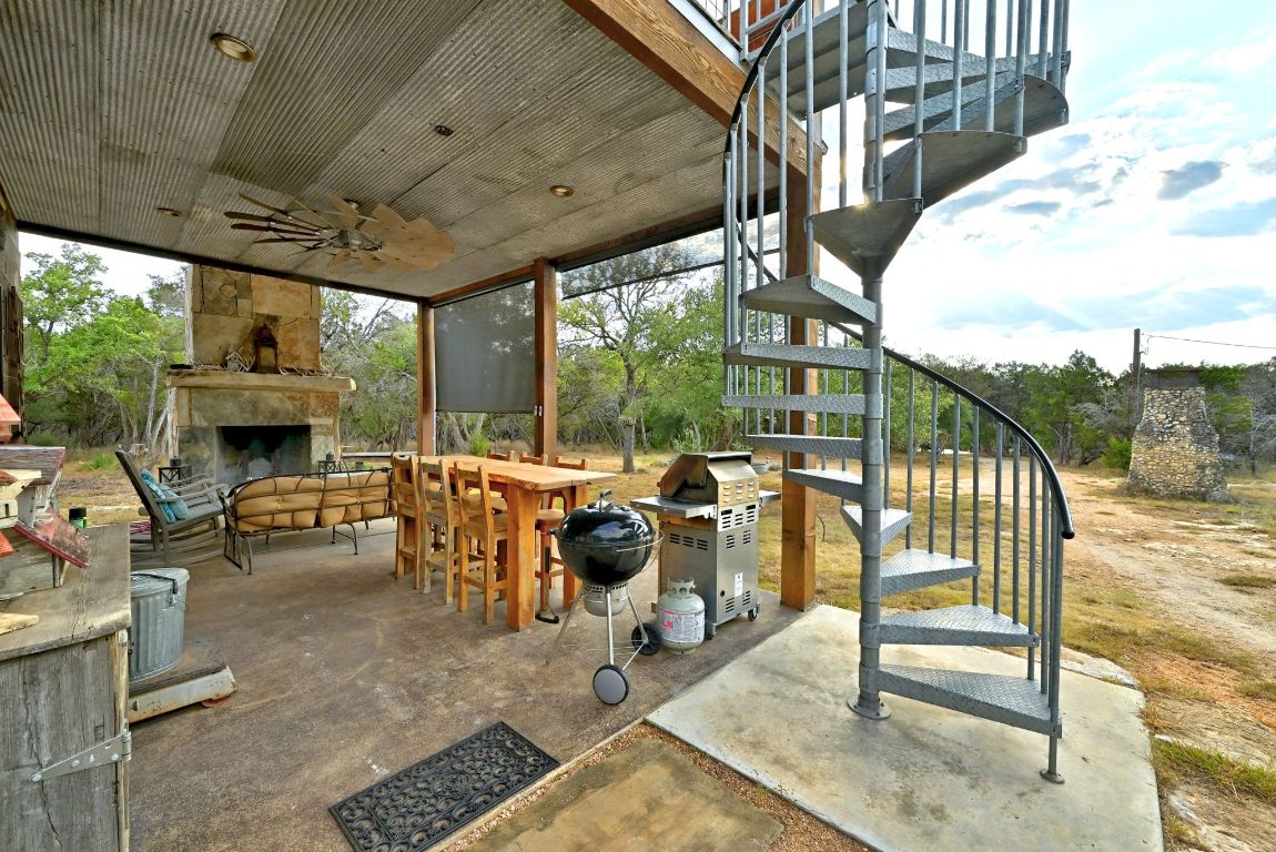 1910 Sandy Point Road Wimberley, TX 78676 - Photo 7 of 40 a view of a porch with furniture and a garden