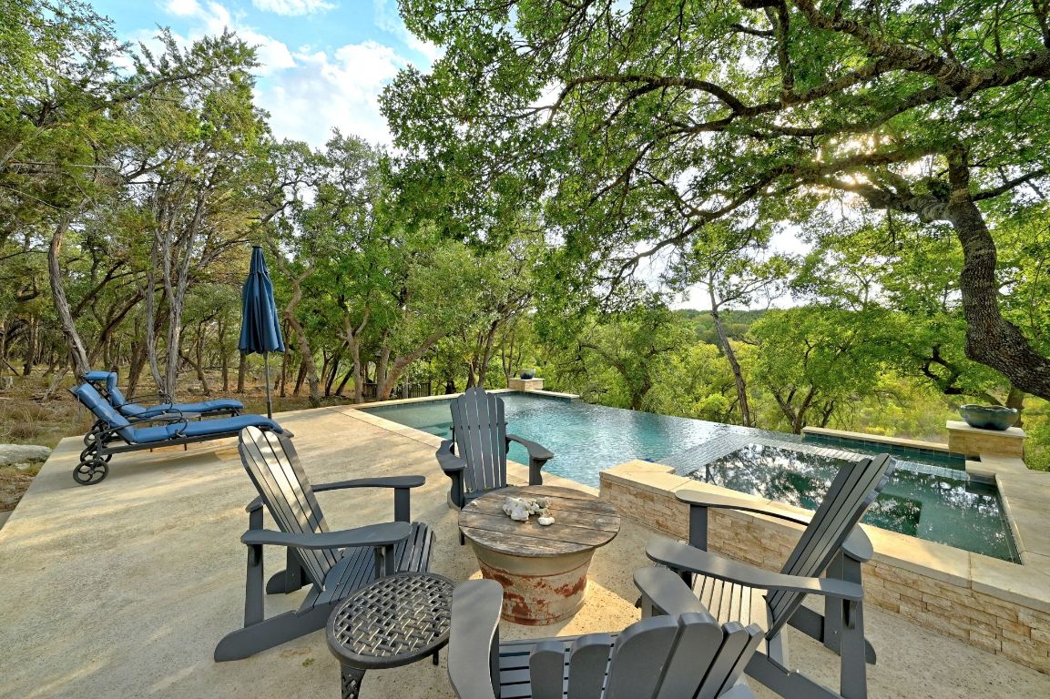 1910 Sandy Point Road Wimberley, TX 78676 - Photo 8 of 40 a view of a chairs and table in patio
