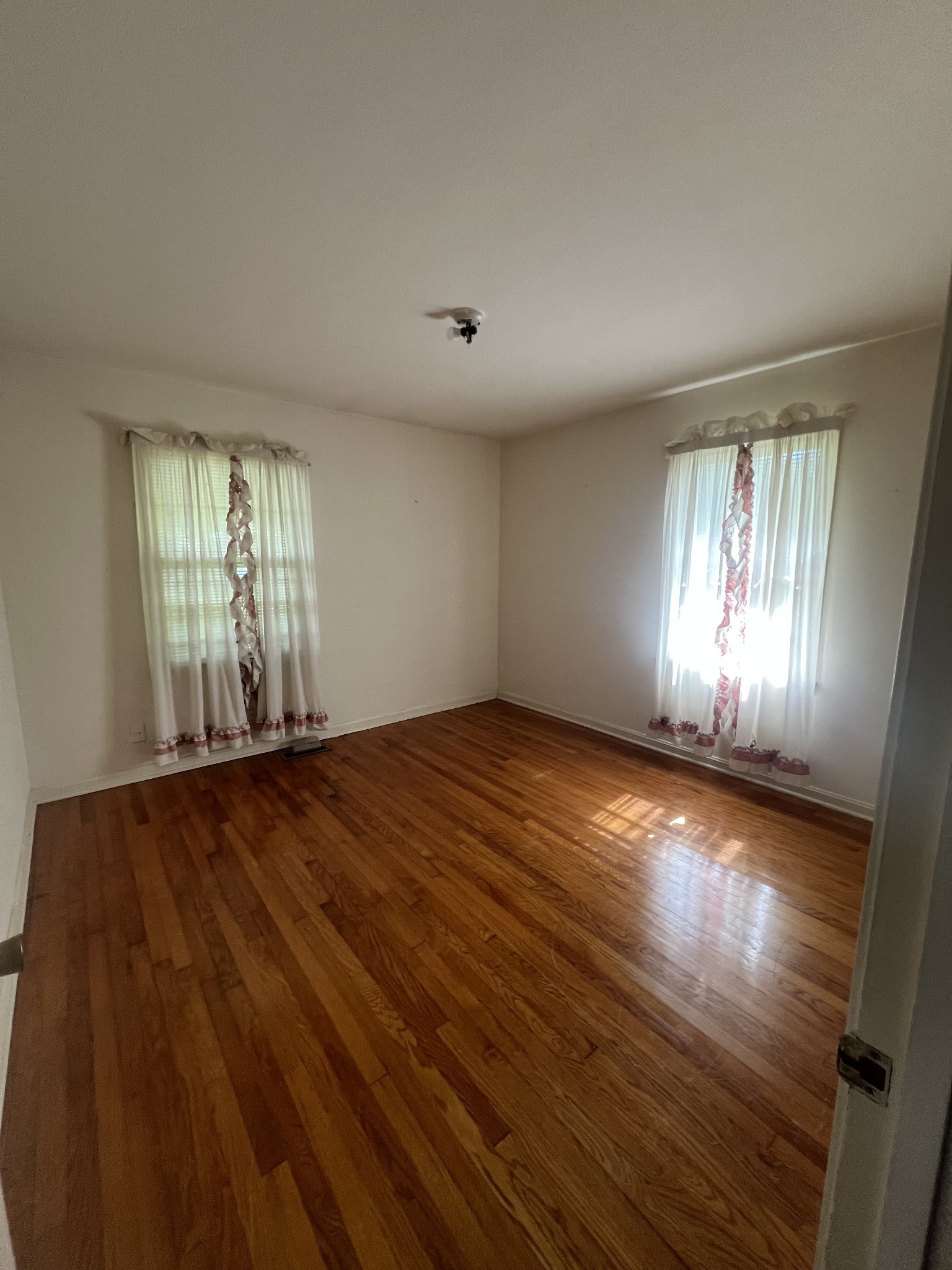 1315 Academy Road Portland, TN 37148 - Photo 19 of 29 an empty room with wooden floor and windows