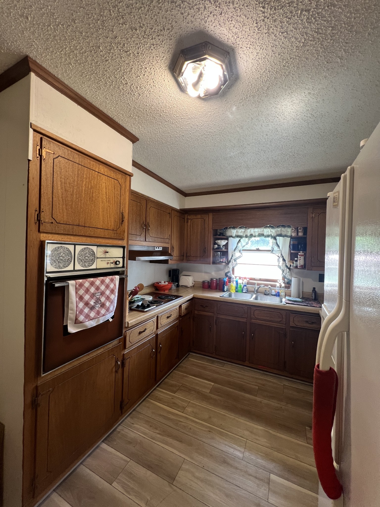 1315 Academy Road Portland, TN 37148 - Photo 24 of 29 a kitchen with stainless steel appliances granite countertop a refrigerator a stove a sink and dishwasher with wooden floor