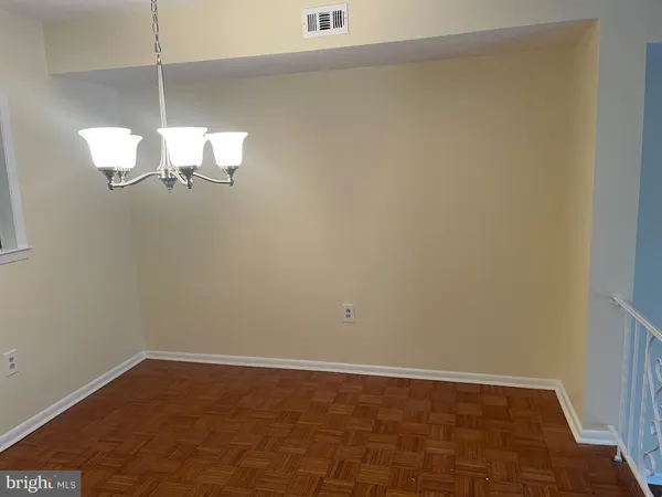 a view of a room with wooden floor and window