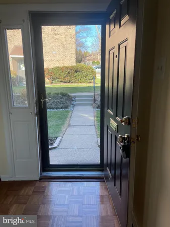 a view of a door and wooden floor in a room