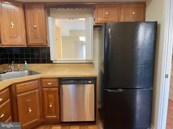 a kitchen with a refrigerator and cabinets