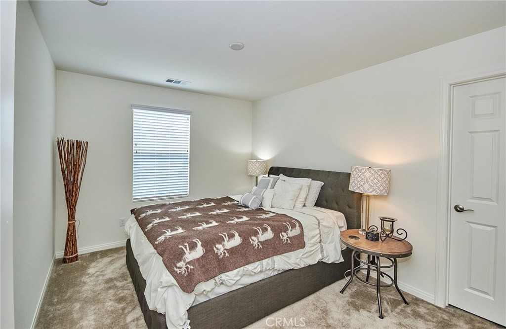 2375 Vineyard Street Upland, CA 91786 - Photo 16 of 58 a bedroom with a bed and a table