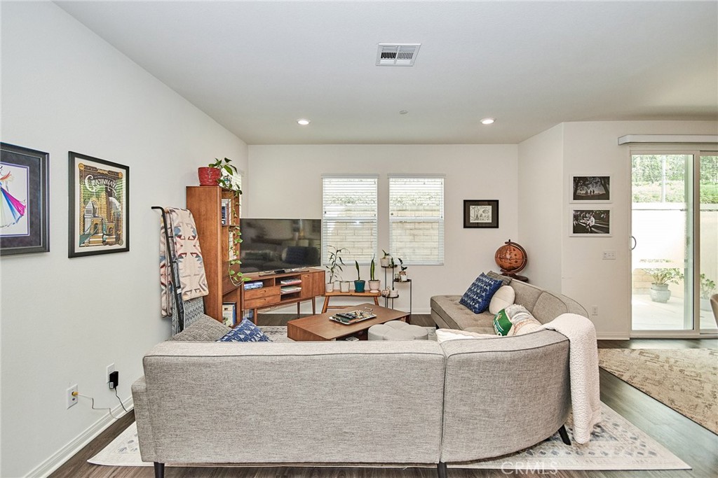 2375 Vineyard Street Upland, CA 91786 - Photo 21 of 58 a living room with furniture a flat screen tv and a large window
