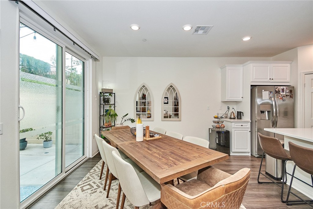 2375 Vineyard Street Upland, CA 91786 - Photo 4 of 58 a room with stainless steel appliances granite countertop a dining table and chairs with wooden floor