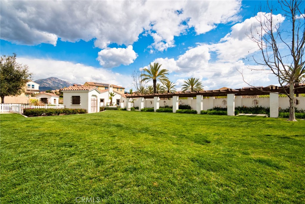 2375 Vineyard Street Upland, CA 91786 - Photo 57 of 58 a view of a white house with a big yard and large trees