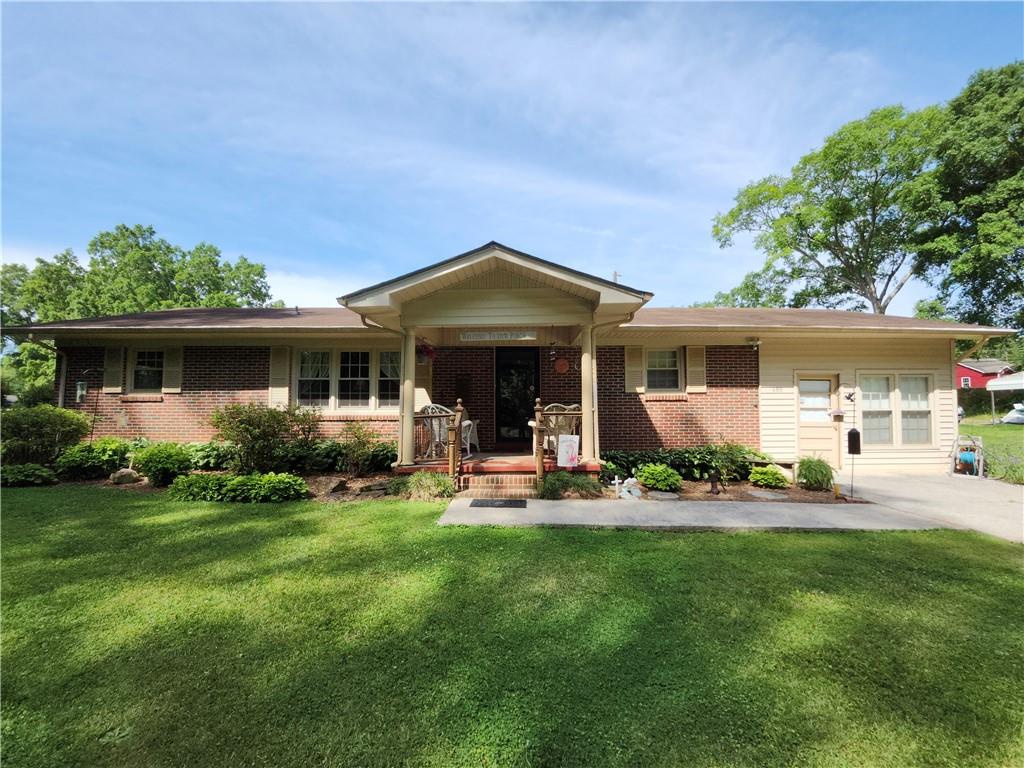 680 Ave F Northeast Rome, GA 30161 - Photo 1 of 1 a front view of a house with a garden and trees
