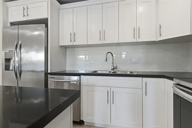 a kitchen with granite countertop a sink and cabinets