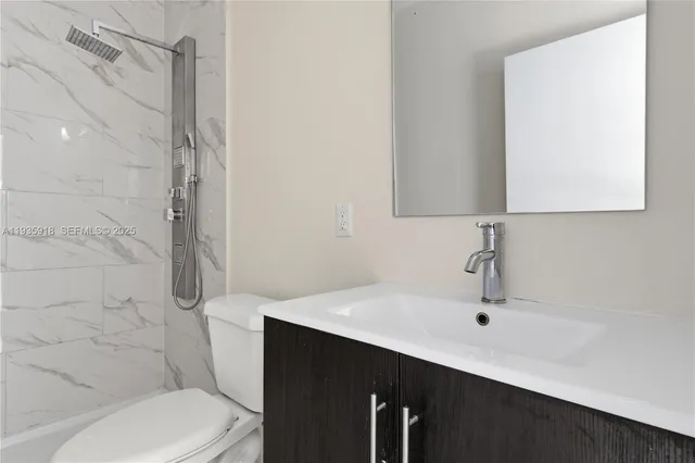 a bathroom with a sink toilet and shower