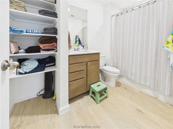 a bathroom with a sink toilet and a mirror