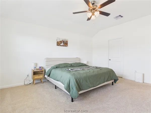 a bedroom with a bed and ceiling fan