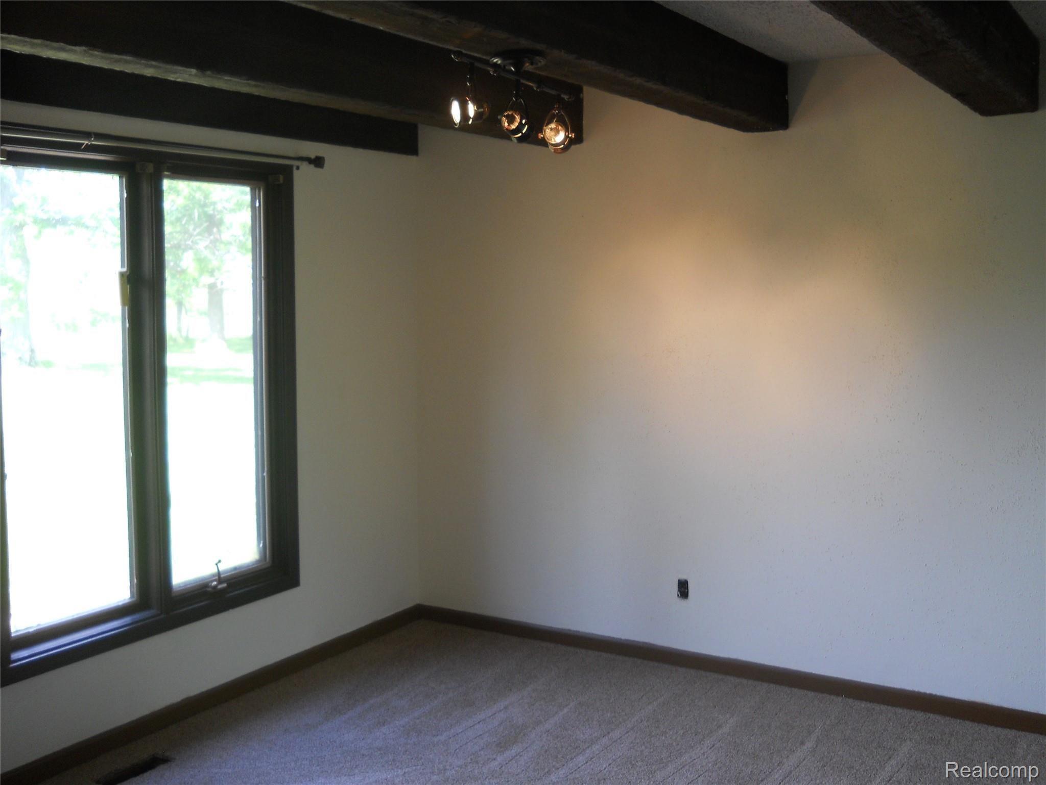 5929 Layton Road Fowlerville, MI 48836 - Photo 10 of 24 formal dining room w/rustic beams