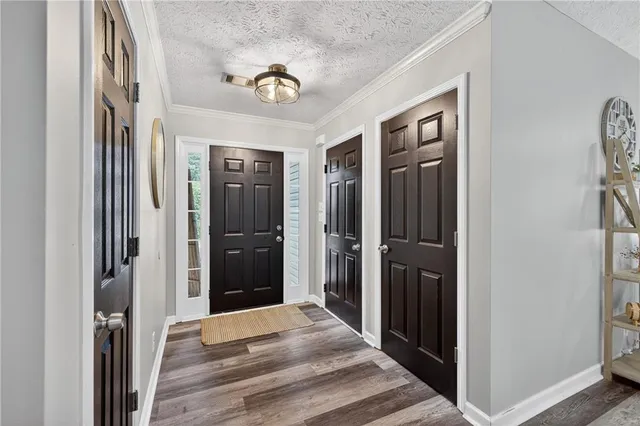 a view of a hallway with wooden floor and closet
