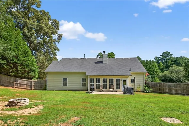 a view of a house with garden and a yard