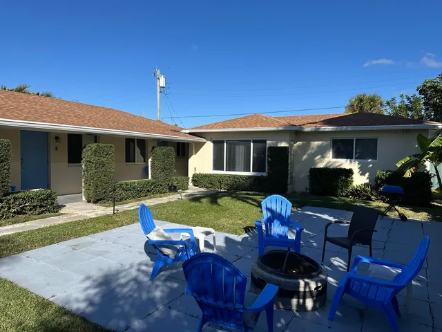 a view of a house with backyard outdoor seating area and furniture