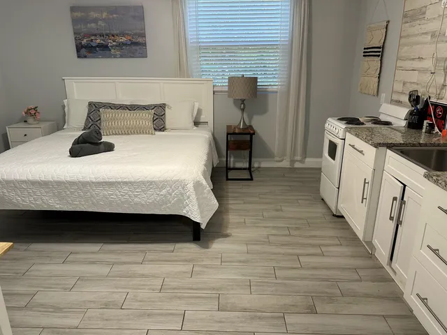 a bedroom with a bed and a stove