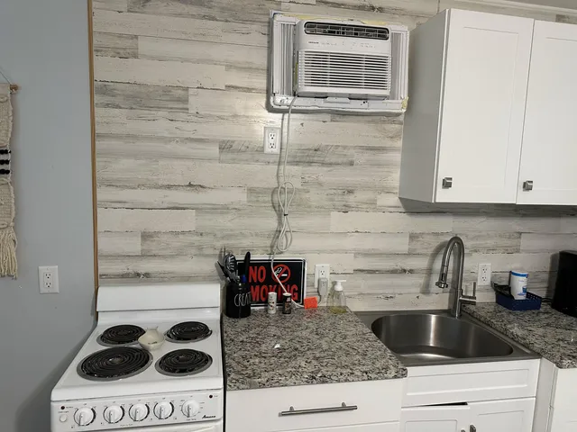 a kitchen with a stove and a cabinet