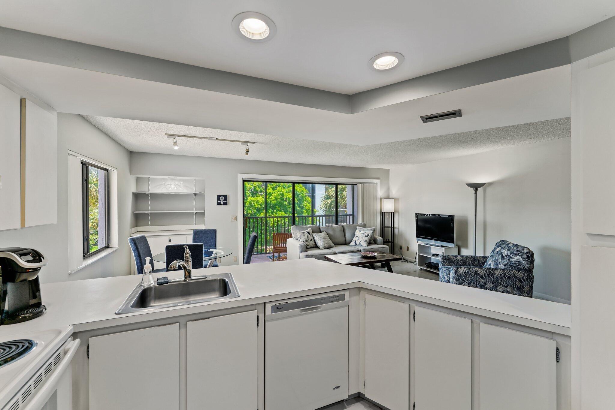 1605 Highway 1, Unit D301 Jupiter, FL 33477 - Photo 19 of 46 a kitchen with a sink appliances and a counter top space