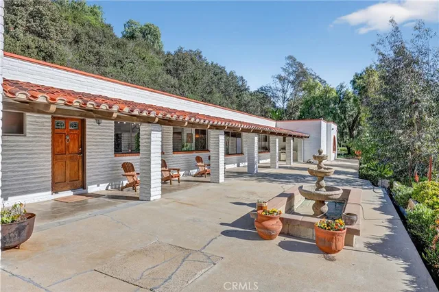 a front view of a house with sitting area