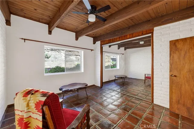 a view of a workspace with furniture and window