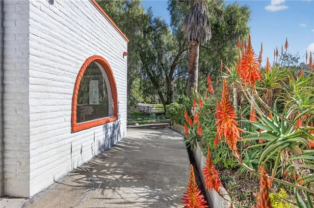 a view of a house with a small yard and a garden