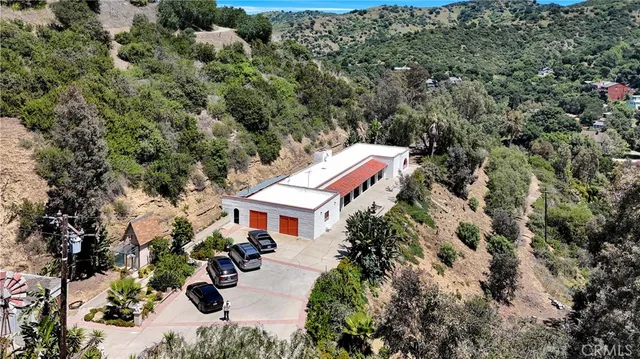 an aerial view of a house with yard and outdoor seating