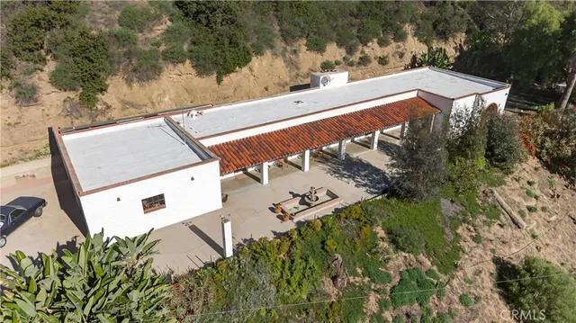 a view of a lush green field with a mountain in the background