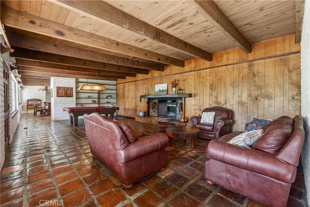 a living room with furniture a fireplace and a table