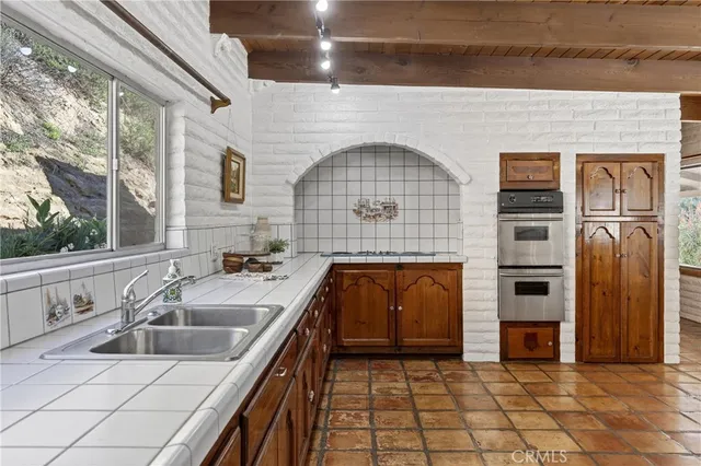 a kitchen with granite countertop a sink and a stove