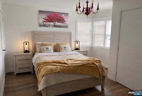 a bedroom with a bed and a chandelier