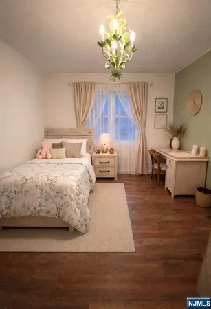 a bedroom with a large bed and a chandelier