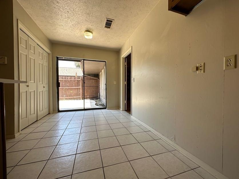 1900 Tree House Lane Plano, TX 75023 - Photo 18 of 18 a view of an empty room with window and chandelier fan