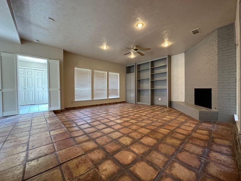 1900 Tree House Lane Plano, TX 75023 - Photo 2 of 18 a view of empty room with a fireplace and cabinet