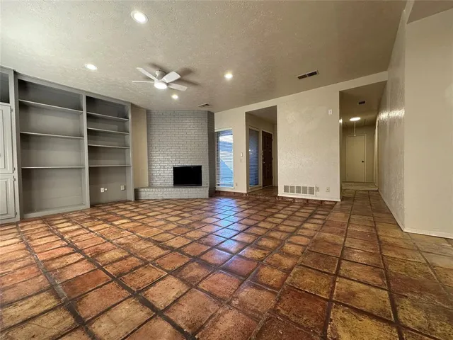 a view of an empty room and a bathroom