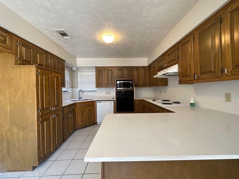 1900 Tree House Lane Plano, TX 75023 - Photo 9 of 18 a kitchen with stainless steel appliances a refrigerator sink and microwave