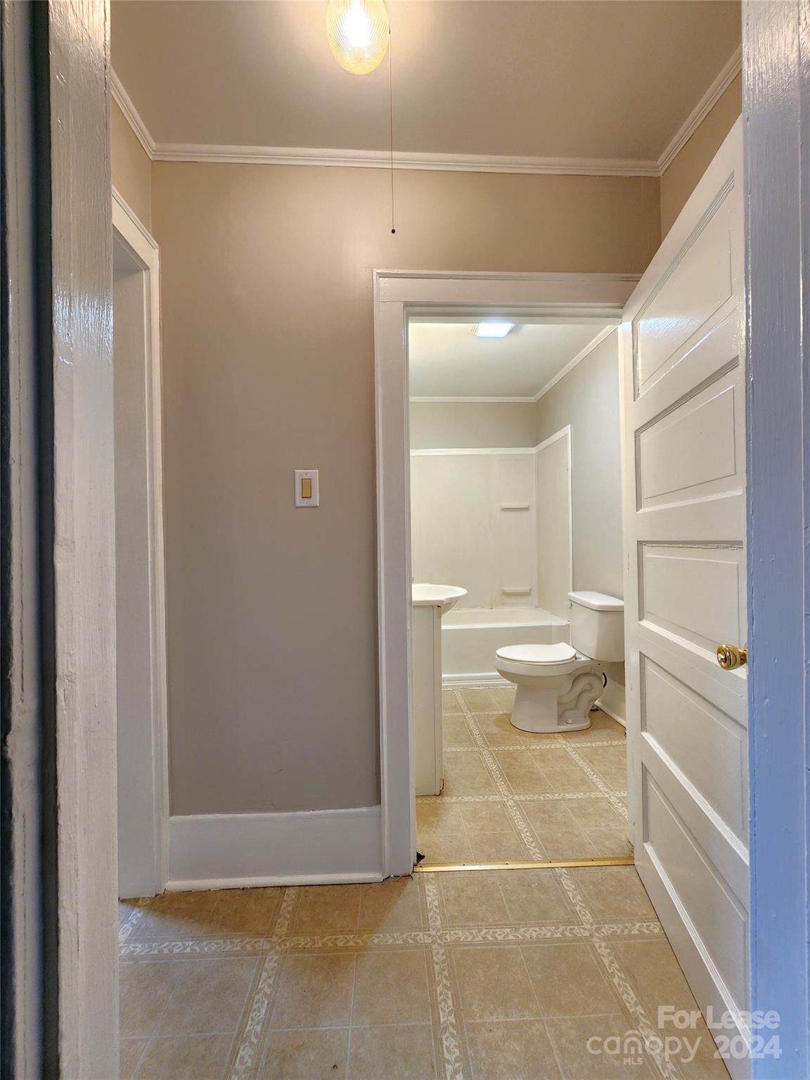 1126 South Fulton Street, Unit B Salisbury, NC 28144 - Photo 12 of 17 a bathroom with a glass door shower a sink and a toilet