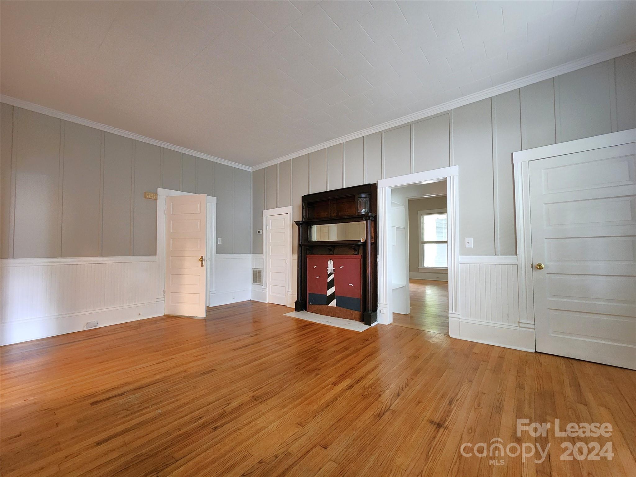 1126 South Fulton Street, Unit B Salisbury, NC 28144 - Photo 6 of 17 a view of a livingroom with wooden floor and a fireplace