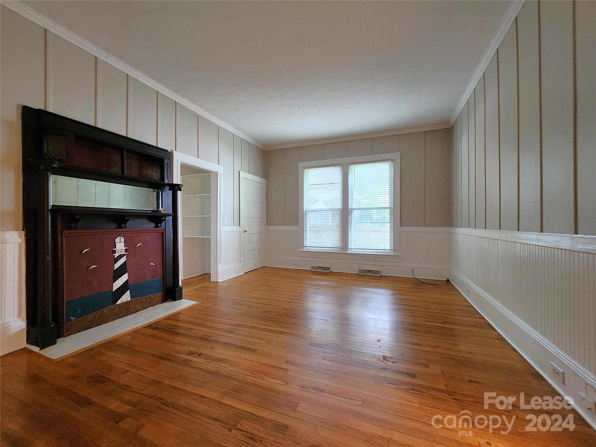 1126 South Fulton Street, Unit B Salisbury, NC 28144 - Photo 7 of 17 a view of an empty room with wooden floor and a window