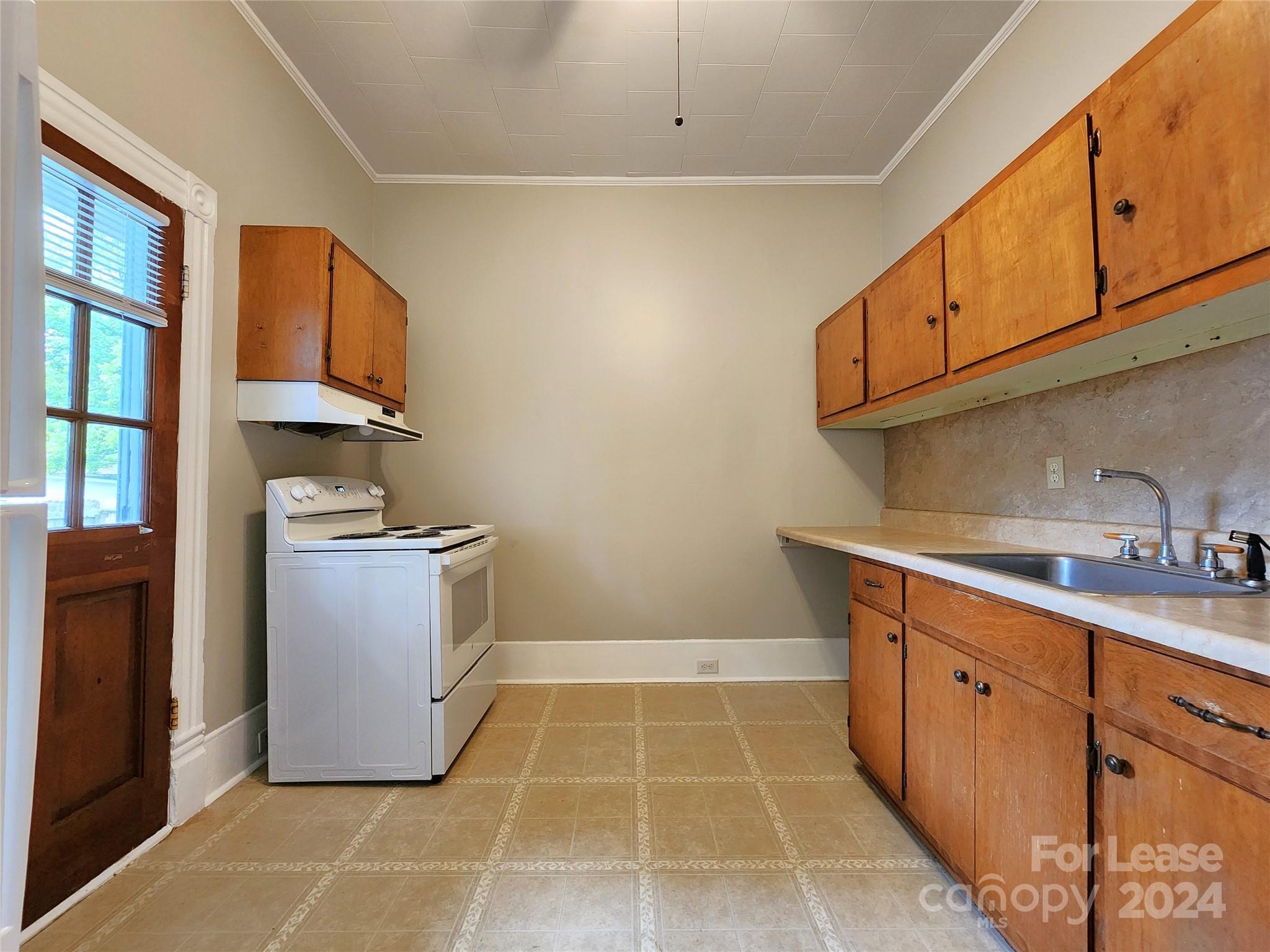 1126 South Fulton Street, Unit B Salisbury, NC 28144 - Photo 8 of 17 a kitchen with a sink stove and cabinets