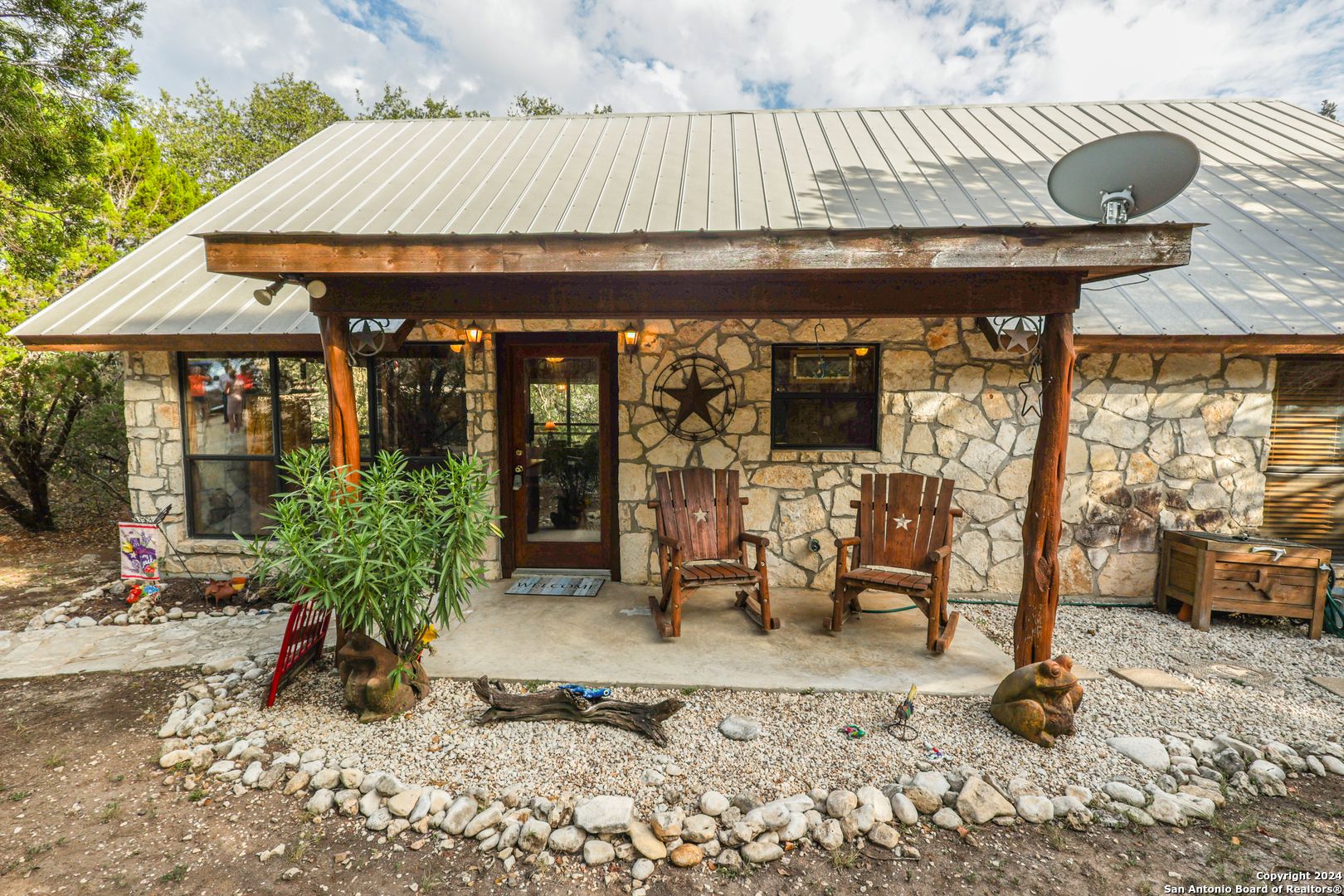 a view of a patio with table and chairs potted plants with wooden floor and fence