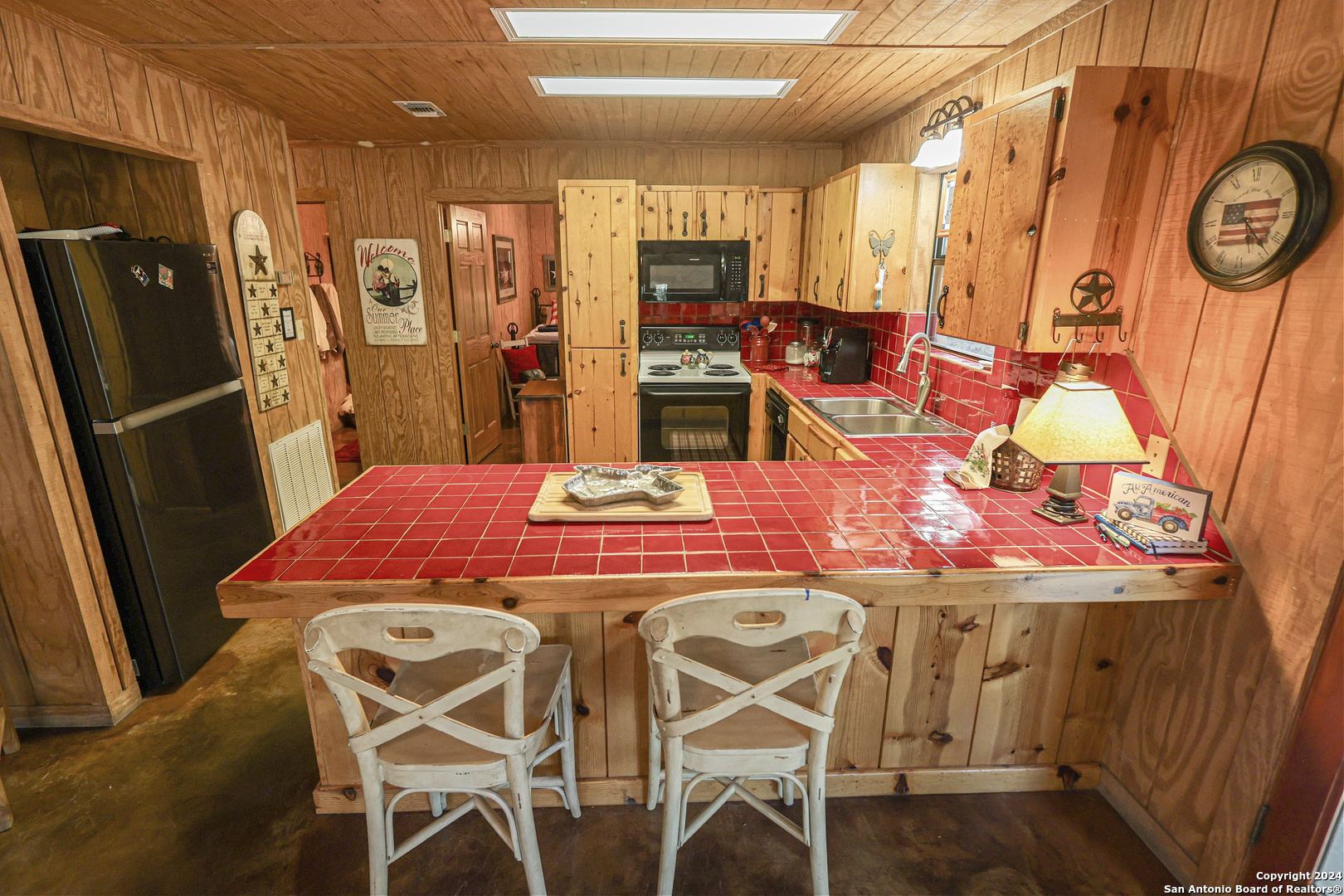 1177 River Road Concan, TX 78838 - Photo 12 of 34 a view of a dining room with furniture and a kitchen view