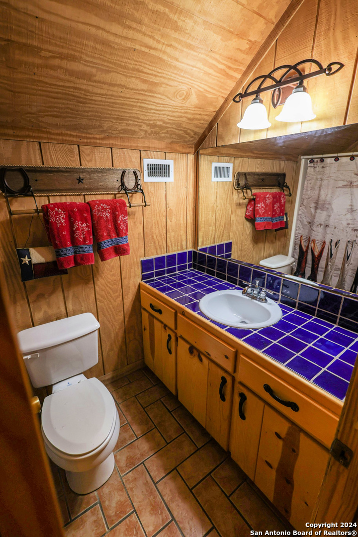 1177 River Road Concan, TX 78838 - Photo 23 of 34 a view of bathroom with sink stove and toilet