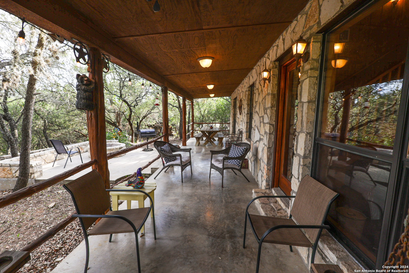 1177 River Road Concan, TX 78838 - Photo 24 of 34 a very nice looking room with lots of furniture and large windows